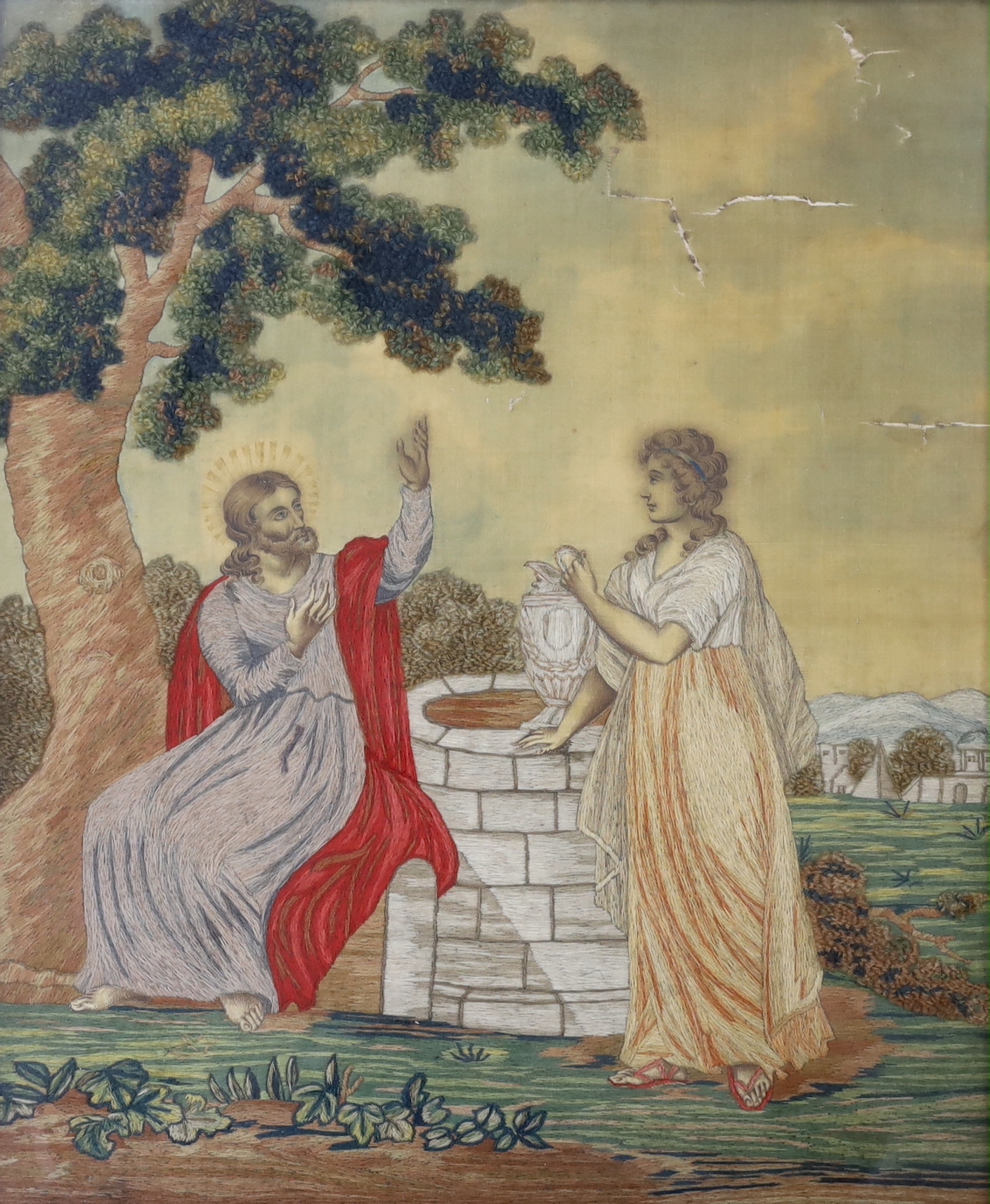 Two Regency wool-worked religious embroideries on silk, one of Christ and Rebecca at the well, the other of St. Francis of Assisi, largest 37.5cm wide x 45cm high